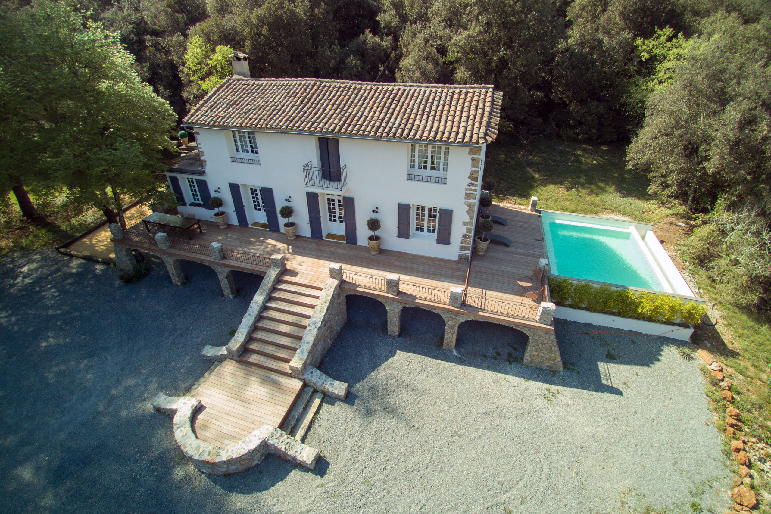 Vue aérienne Mas La Solarie – Mariage Cévennes Vue aérienne du Mas La Solarie avec bâtisse, terrasse et piscine, lieu de mariage et réception dans les Cévennes
